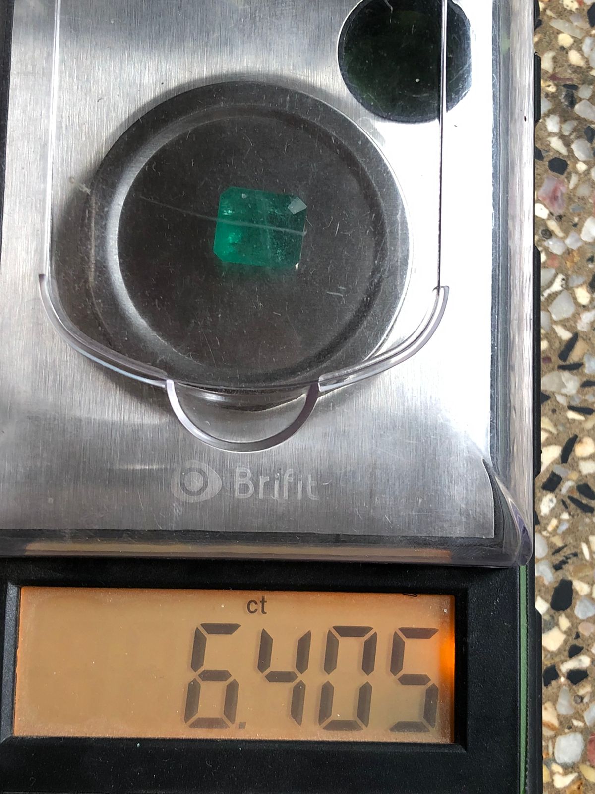 6.405 Carat Zambian Emerald on Weight Scale